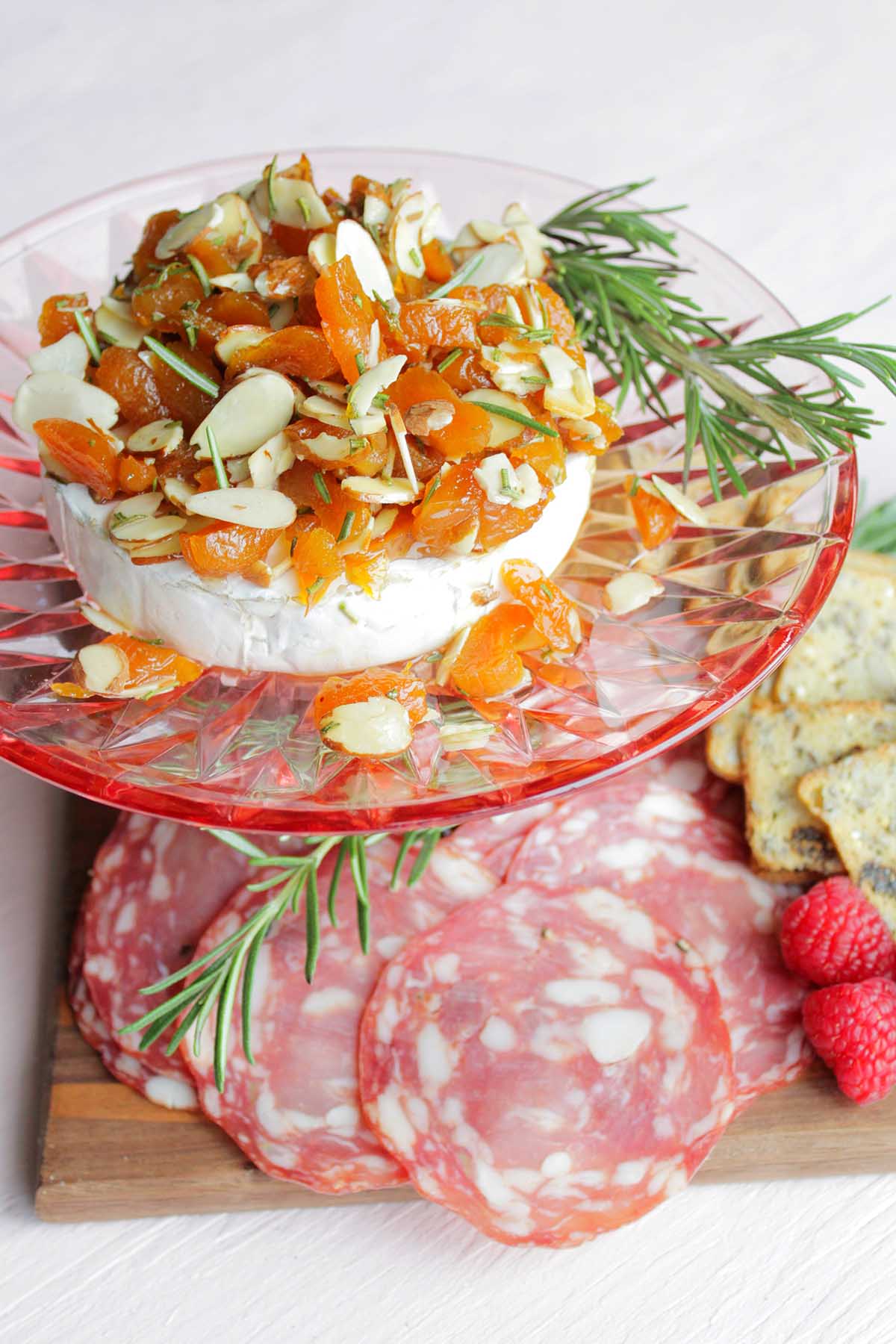 honey and apricot baked brie on pink platter.