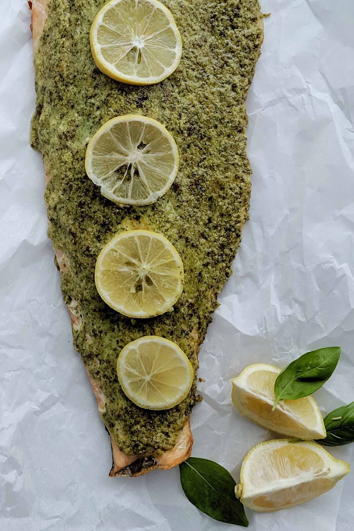 cooked crusted salmon topped with lemon slices.