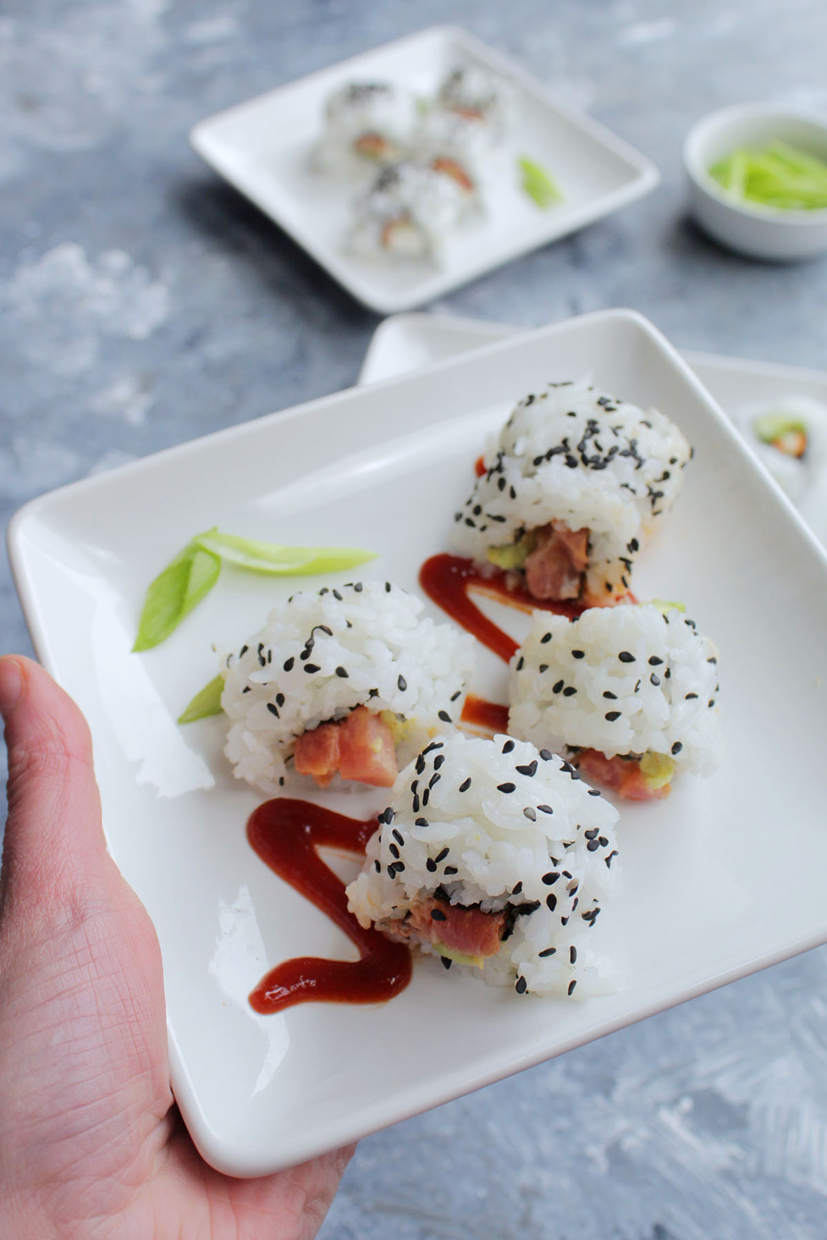 spicy tuna roll on small serving plate.