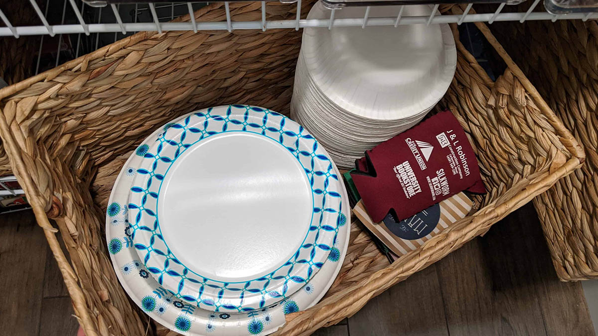 basket with paper plates and bowls