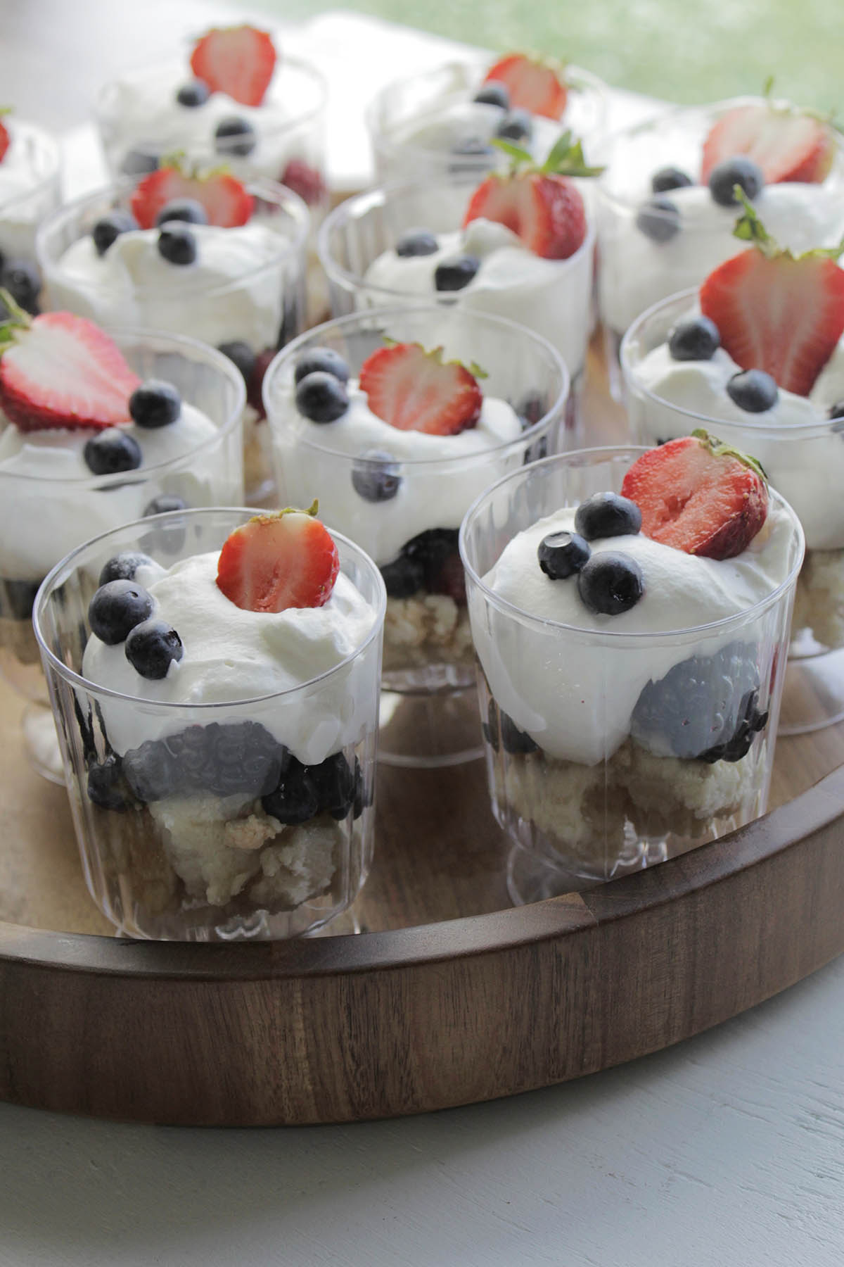 mini trifles with strawberries, blueberries, and whipped cream.