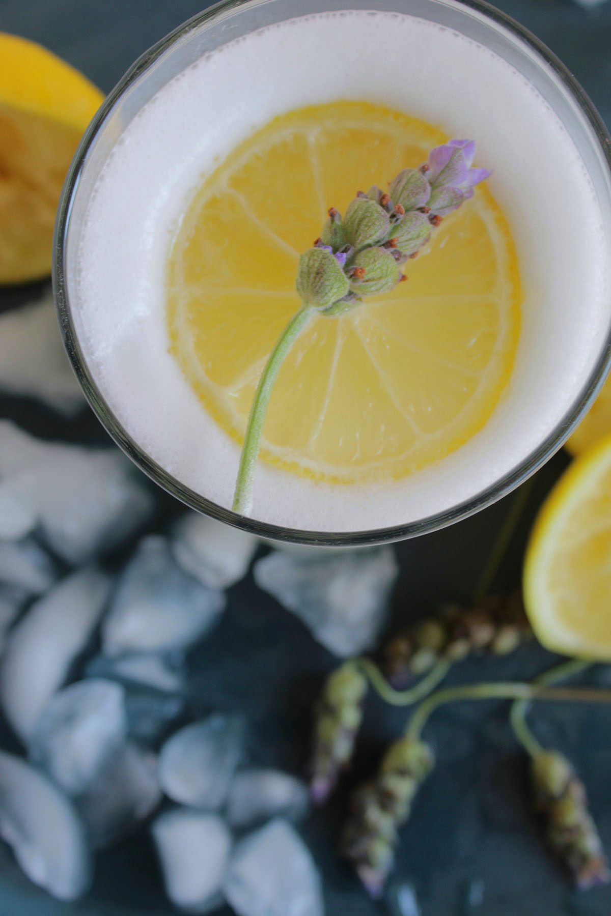 lavender pisco sour garnished with lemon slice.