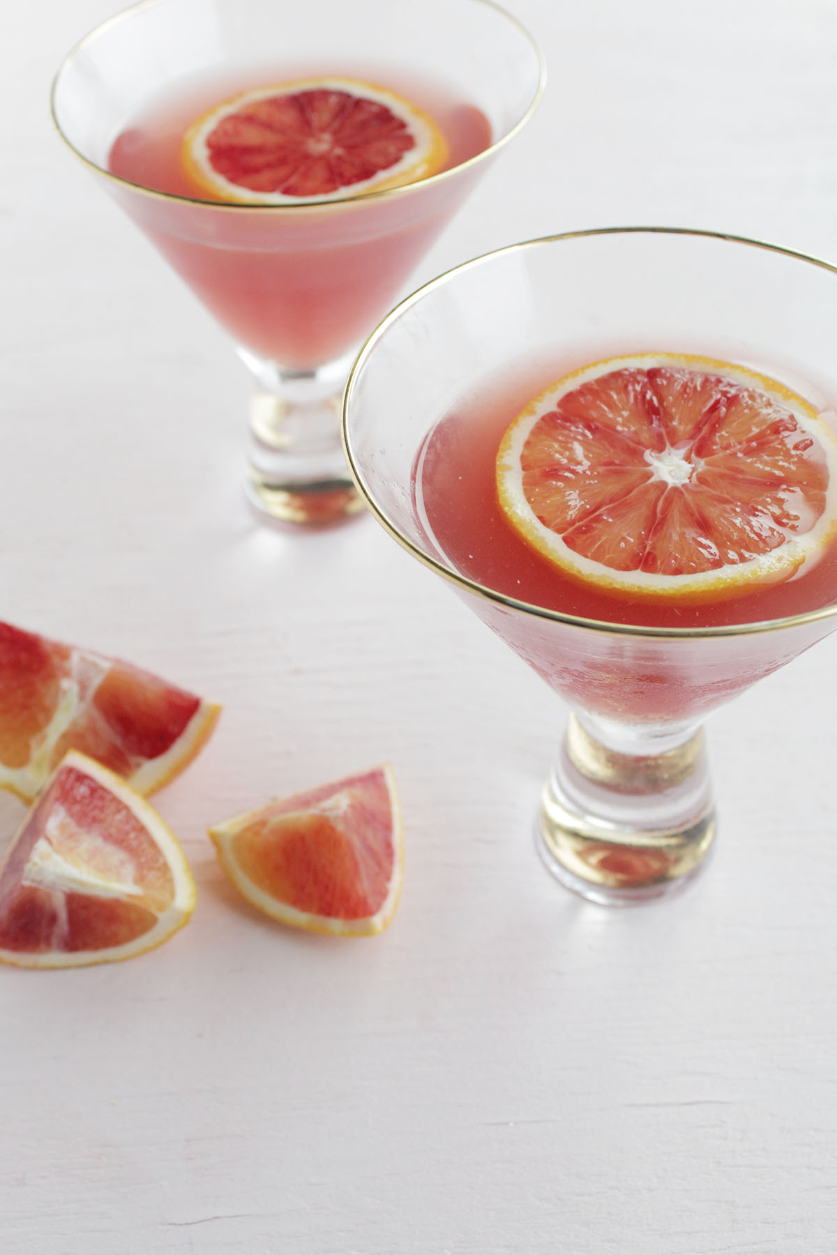 This classic and fruity gin martini recipe is sweetened with a hint of blood orange and pomegranate juice. This is an upscale, yet secretly easy martini recipe that would be perfect for the winter or holiday season, but you can definitely drink it all year round! The London dry gin gives keeps this cocktail tasting fresh, and the fruit juices add a sweetness to the gin! You'll also learn the various styles of gin in this post, and how to pick a bottle of gin you'll love!