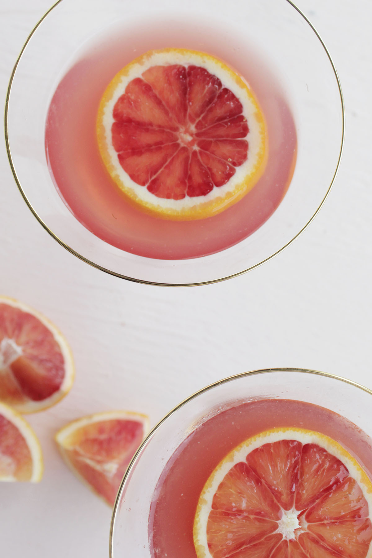top of two pomegranate and blood orange martinis.