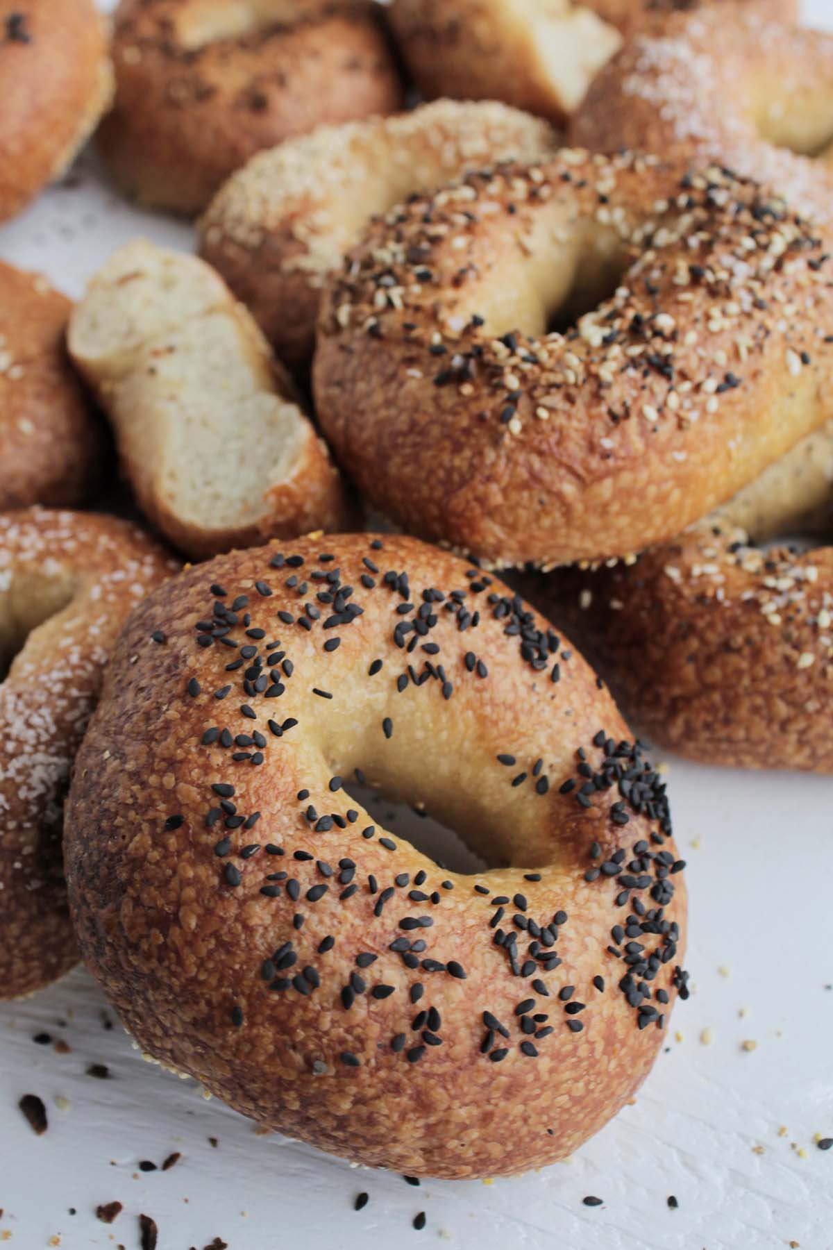 golden brown bagels topped with black sesame seeds.