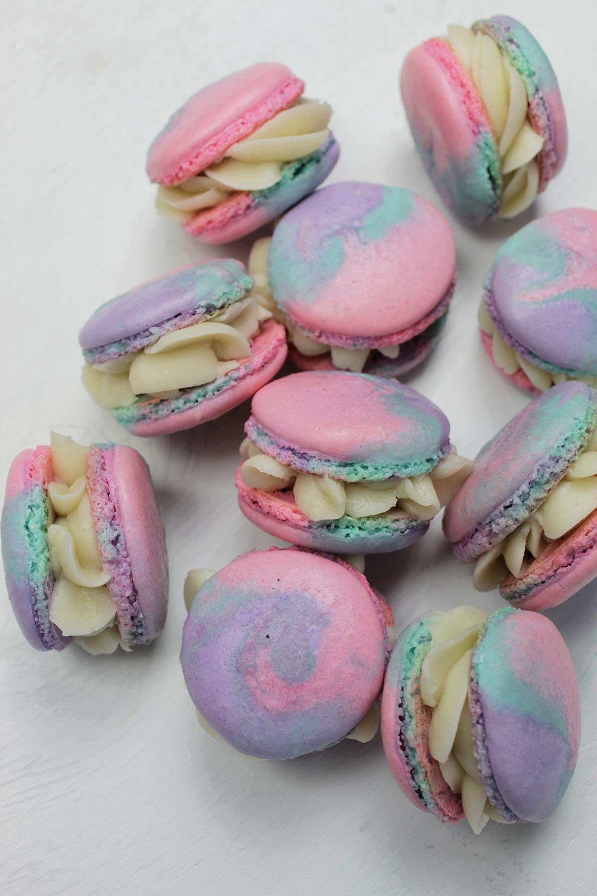 pile of macarons with tie dye shells.