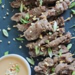asian beef brochettes with peanut dipping sauce.