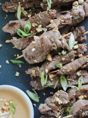 Asian beef brochettes with peanut dipping sauce.