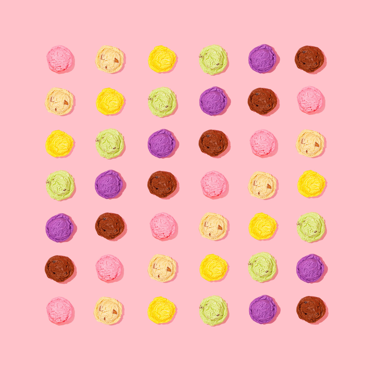 various ice cream flavors on pink background.