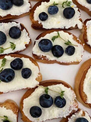 crostini toasts with cheese and blueberries.