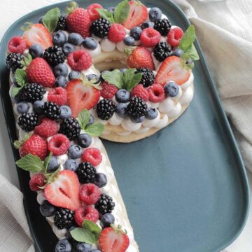 shortbread cookie cake topped berries in the shape of the letter P.