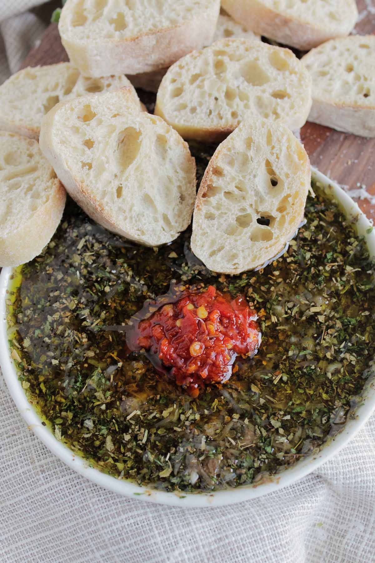 French bread dipped into olive oil herbed dip.
