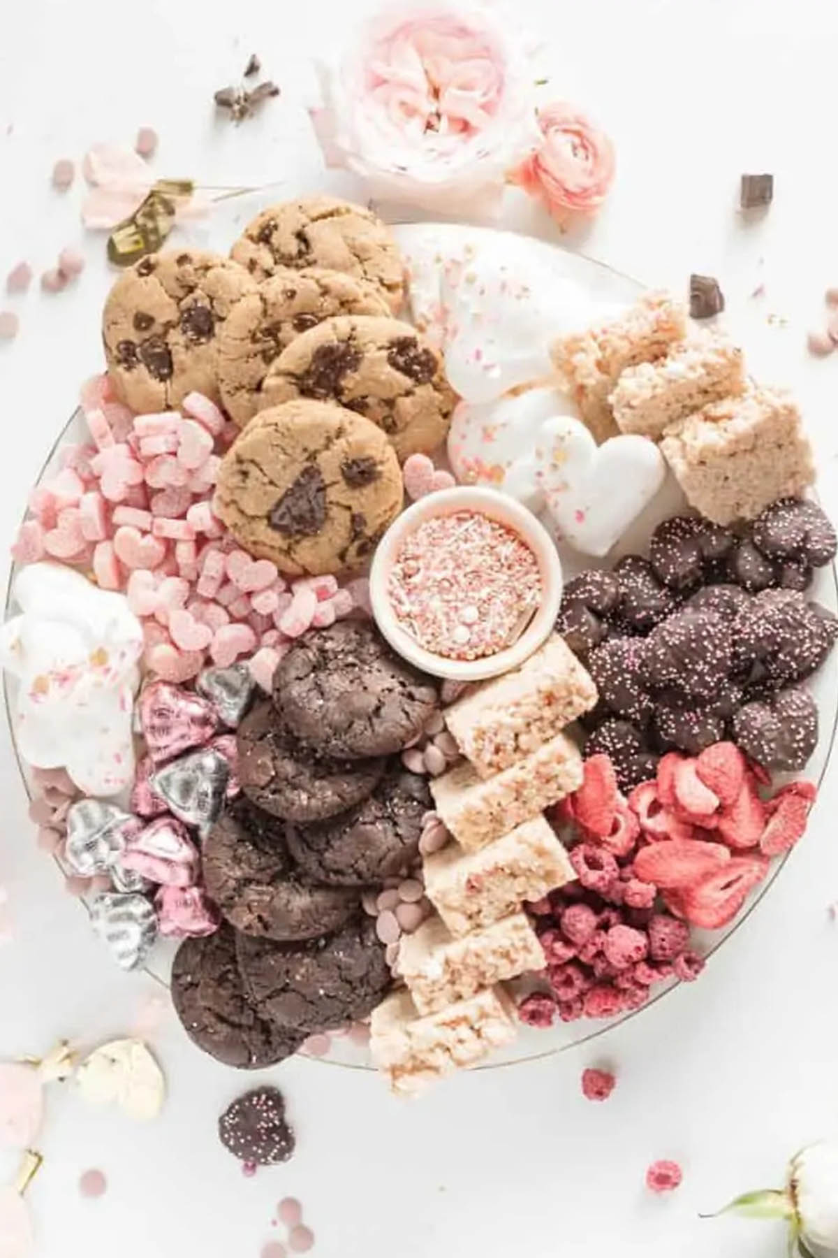 large serving platter filled with cookies, rice krispie treats, and candies.