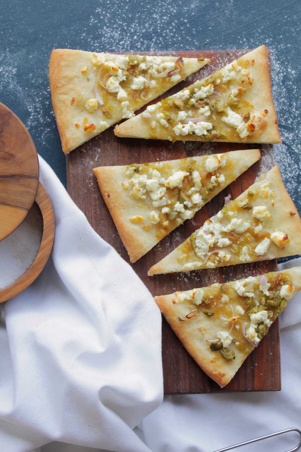 goat cheese and green olive slices of flatbread pizza