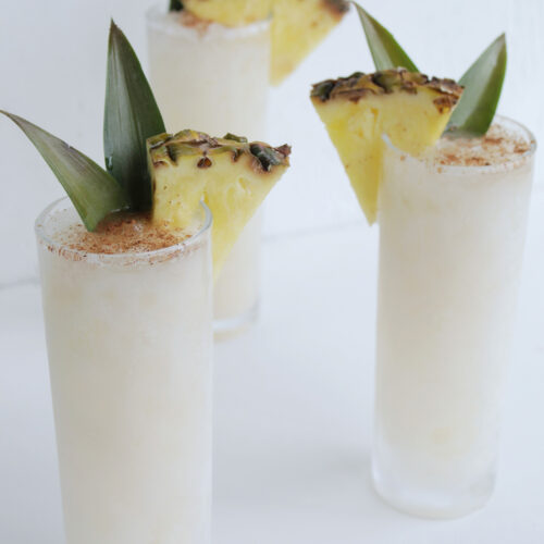 white tropical whiskey cocktail with pineapple garnish.