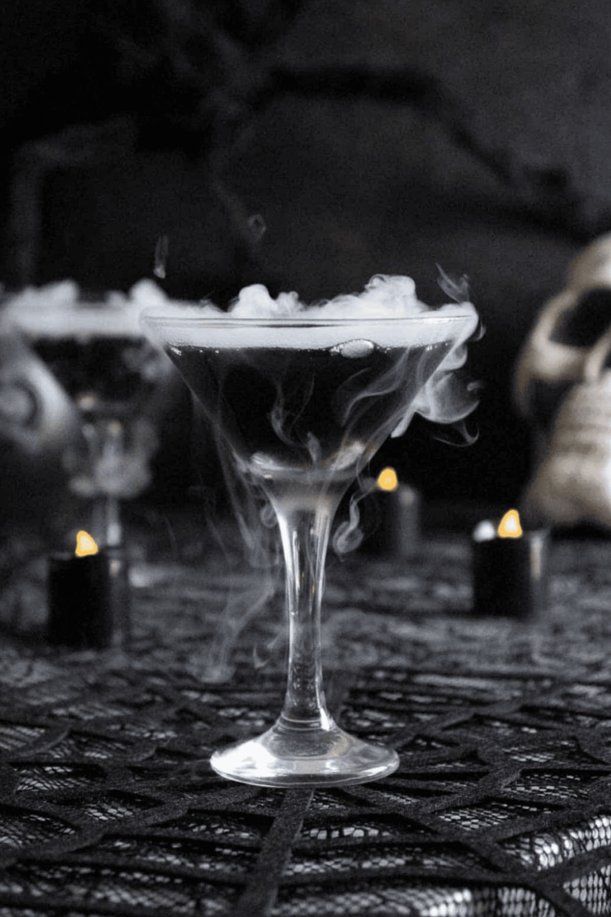 black Halloween cocktail with dry ice