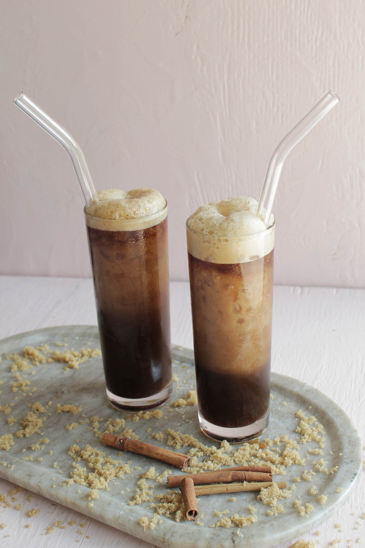 two cold espresso coffee drinks in tall glass.