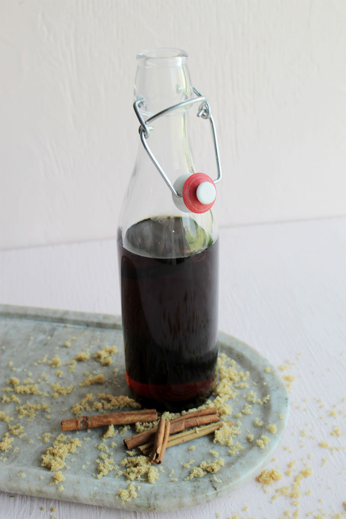 glass bottle filled with brown liquid syrup.