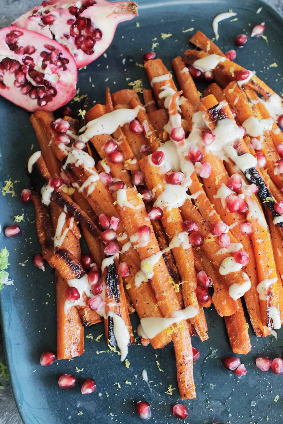 oven roasted carrots with pomegranate seeds on top