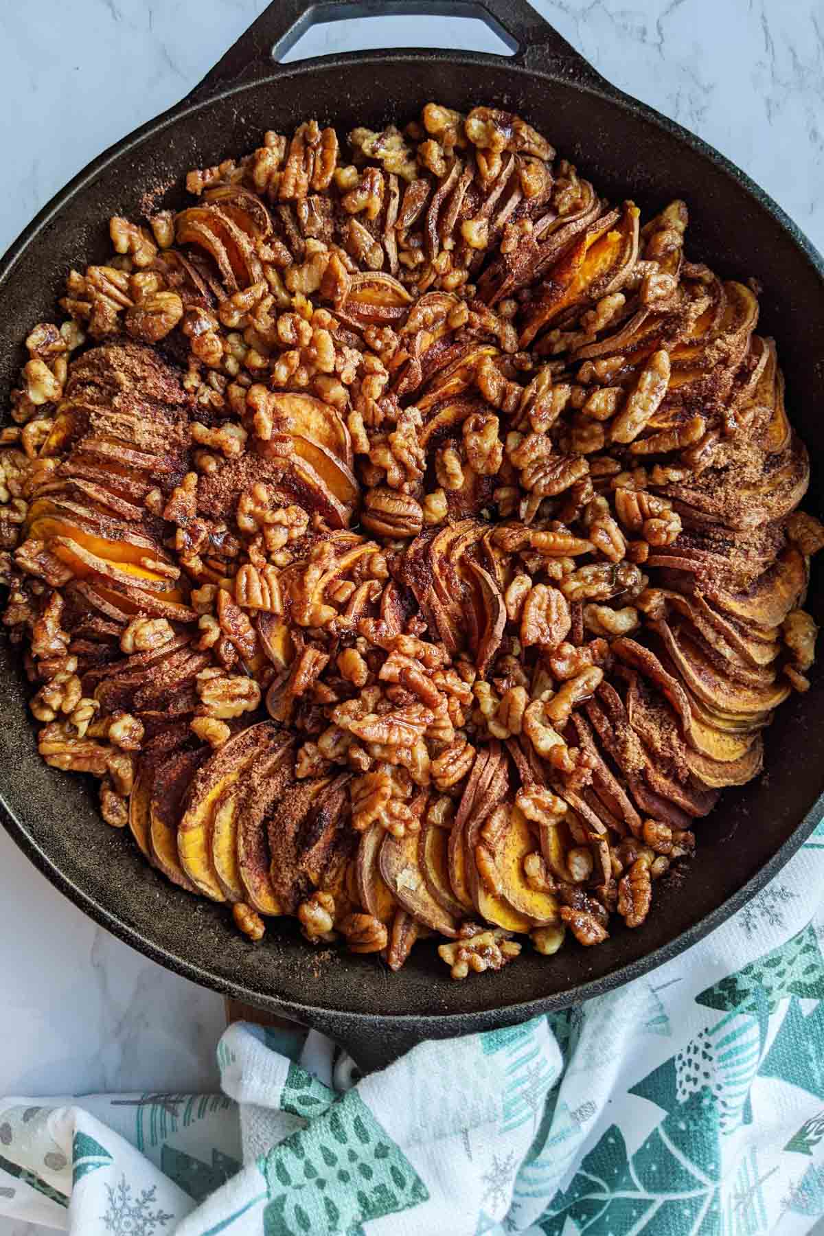 sweet potatoes in skillet topped with nuts
