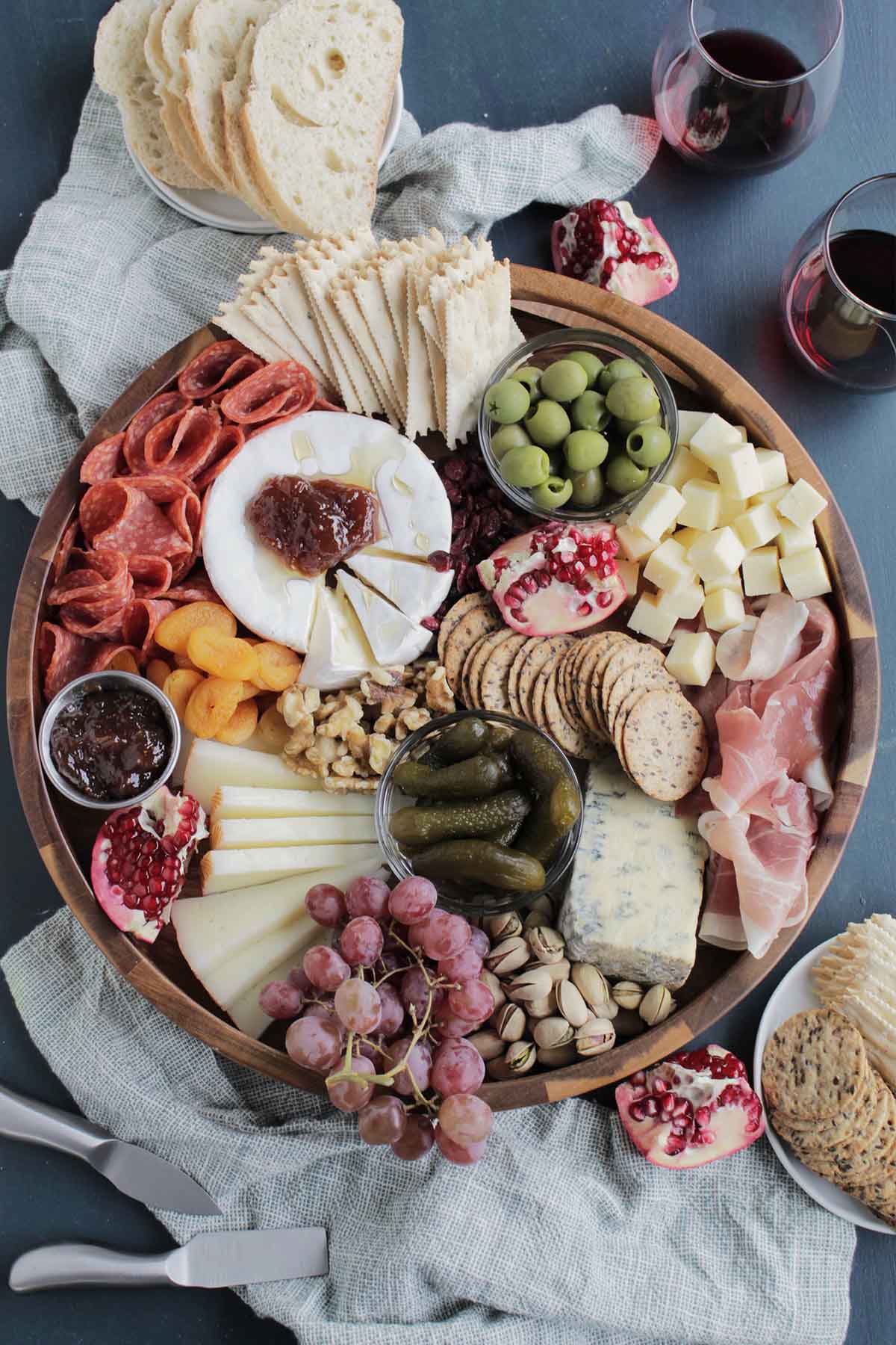 cheese board with wine glasses and bread.
