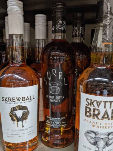various Whiskey bottles on a store shelf.