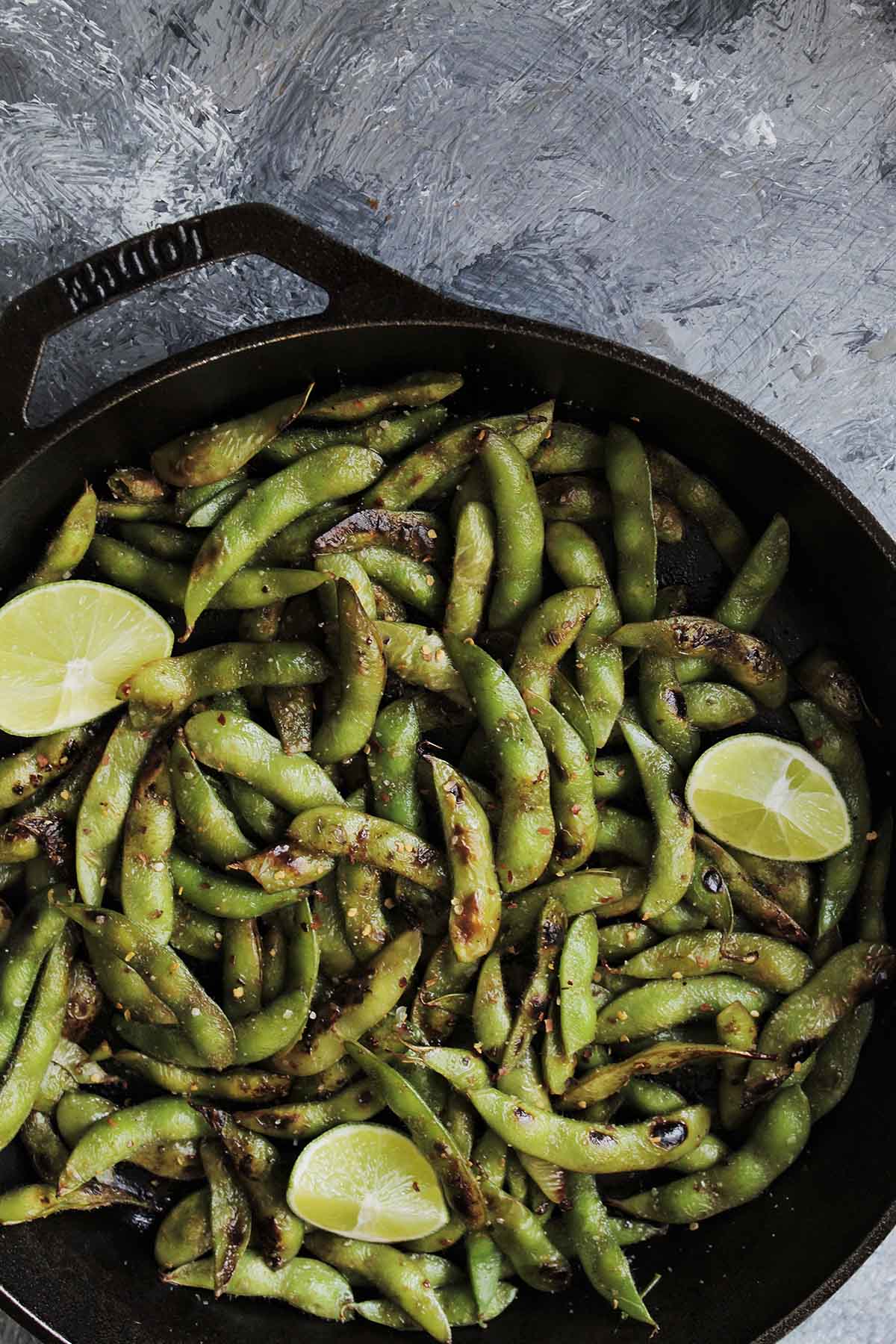 unshelled edamame in a cast iron skillet