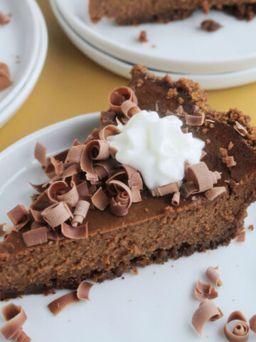 chocolate pumpkin pie piece topped with whipped cream.