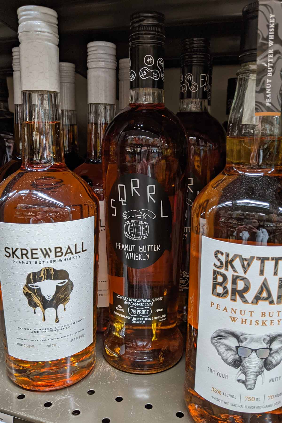 Skrewball, Sqrrl, and Skatterbrain alcohol bottles.