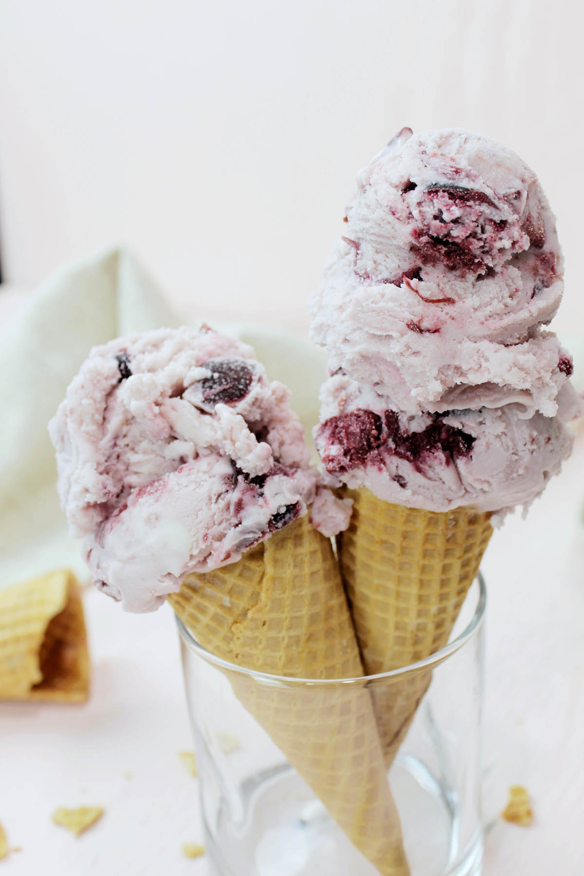 black cherry ice cream cones standing up in a glass.