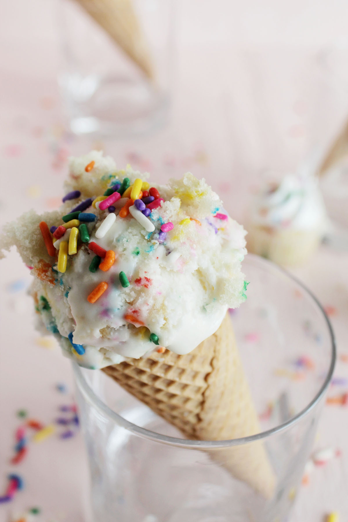 vanilla ice cream with rainbow sprinkles with cake chunks.