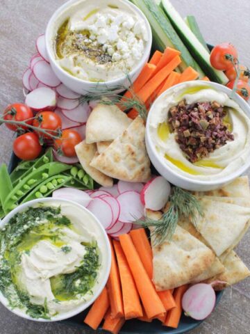 mezze board with various dips, breads and vegetables.
