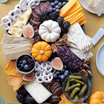 colorful fall cheese board with various ingredients