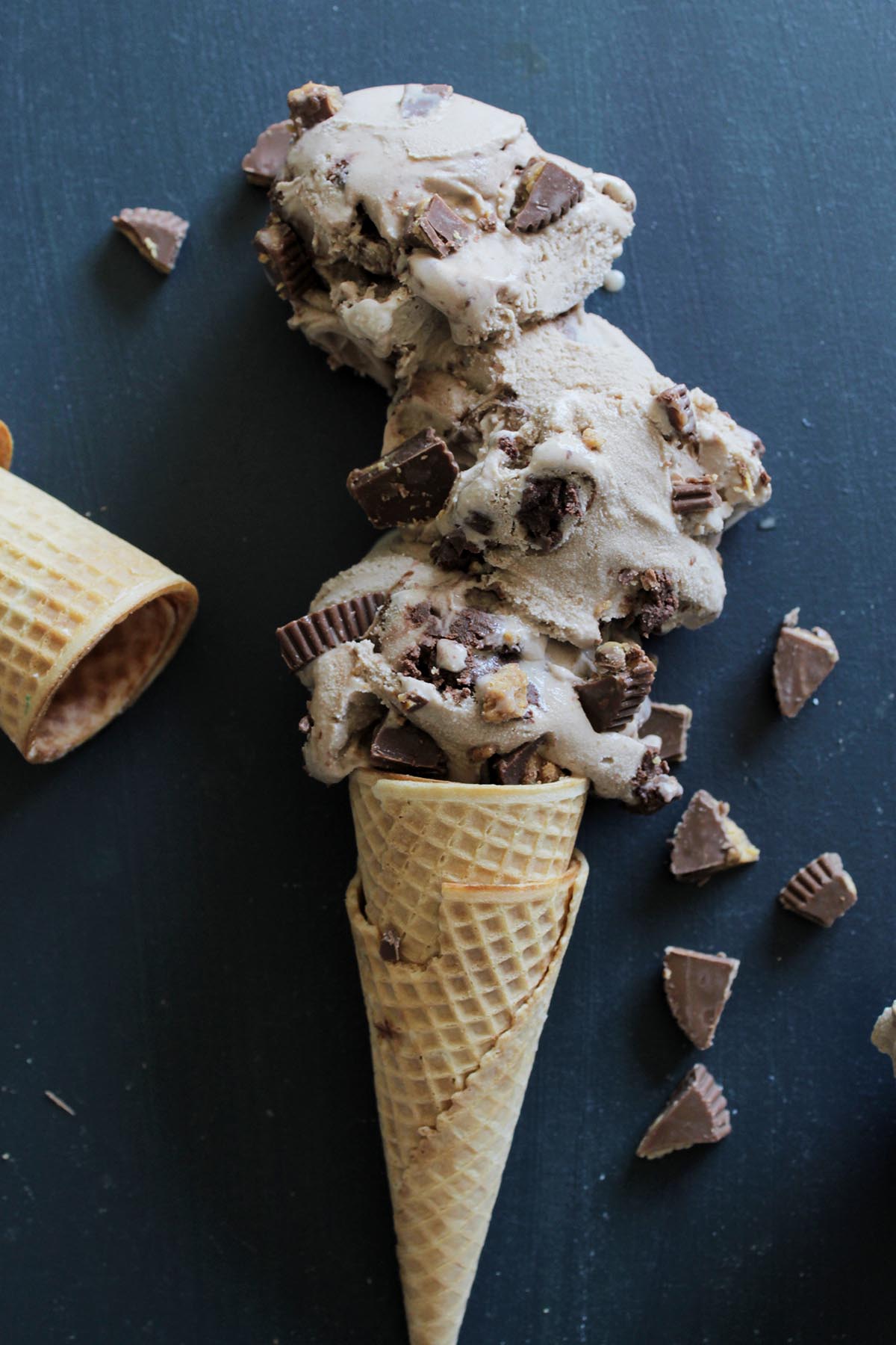 moose tracks ice cream cone laying on blue background.