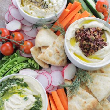 hummus platter with vegetables and pita.