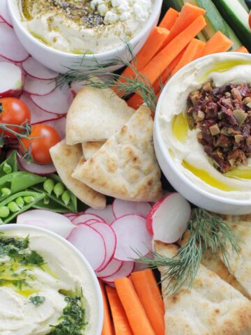 hummus platter with vegetables and pita.