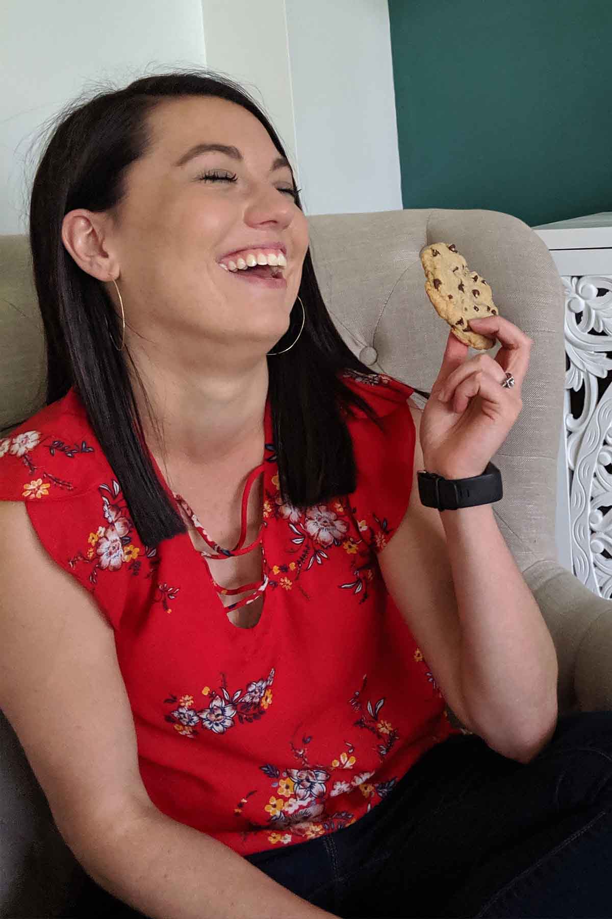 girl laughing with a cookie in hand.