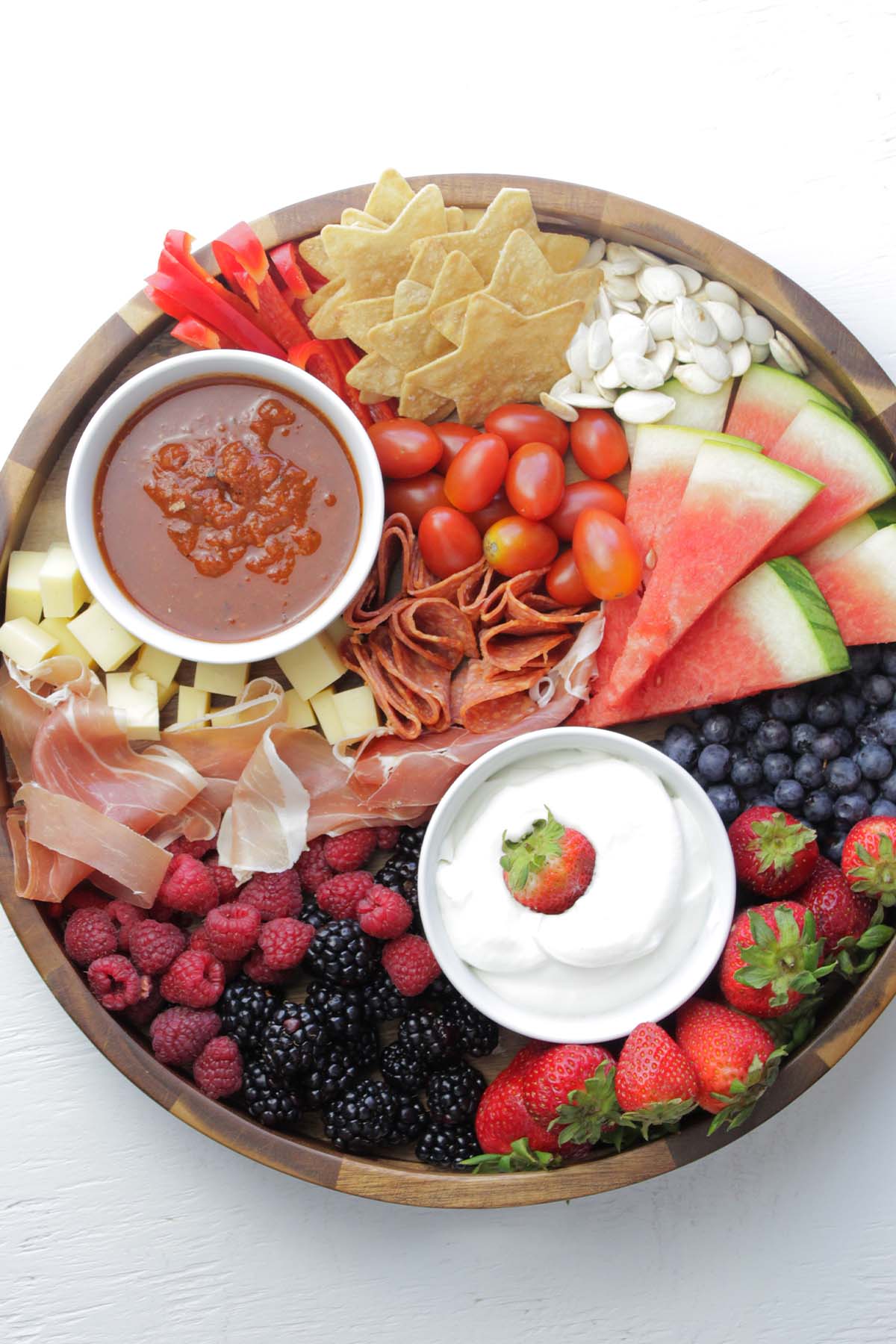 summer cheese board with fruit, cheese, and dips