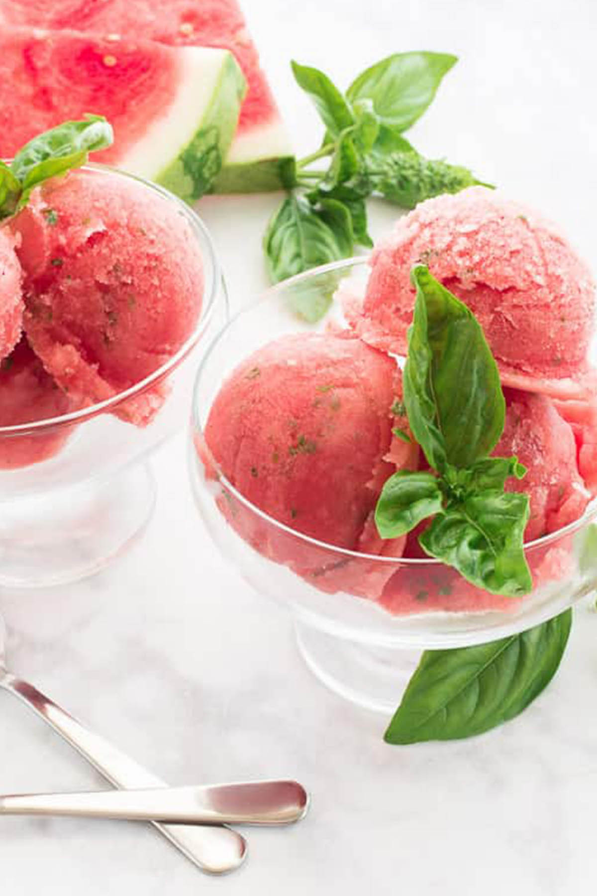 watermelon and basil sorbet in glass serving bowl.