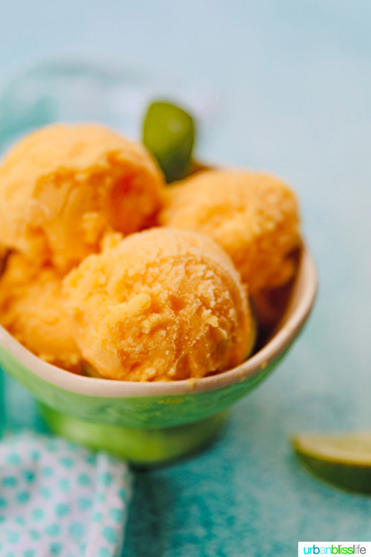 pineapple mango sorbet in green serving bowl.