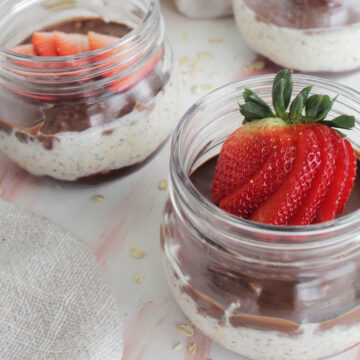 overnight oats in a mason jar topped with strawberry.