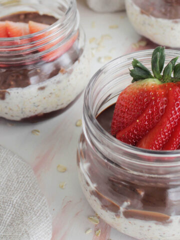 overnight oats in a mason jar topped with strawberry.