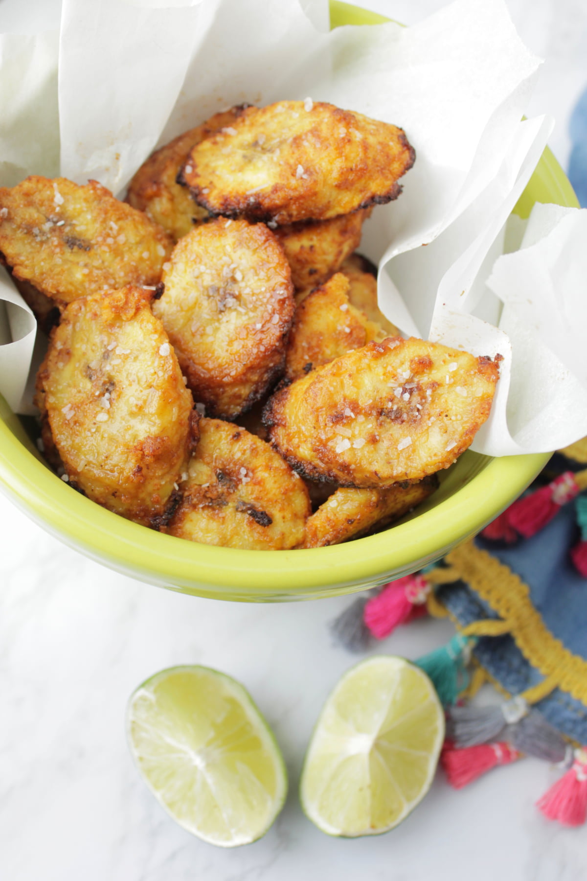 air fried plantains next to lime wedges.