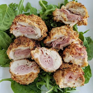air fryer chicken on bed of greens.