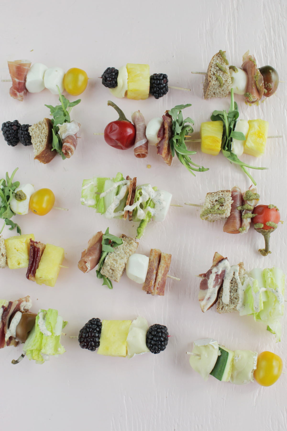 15 different appetizer skewer combinations on toothpicks.