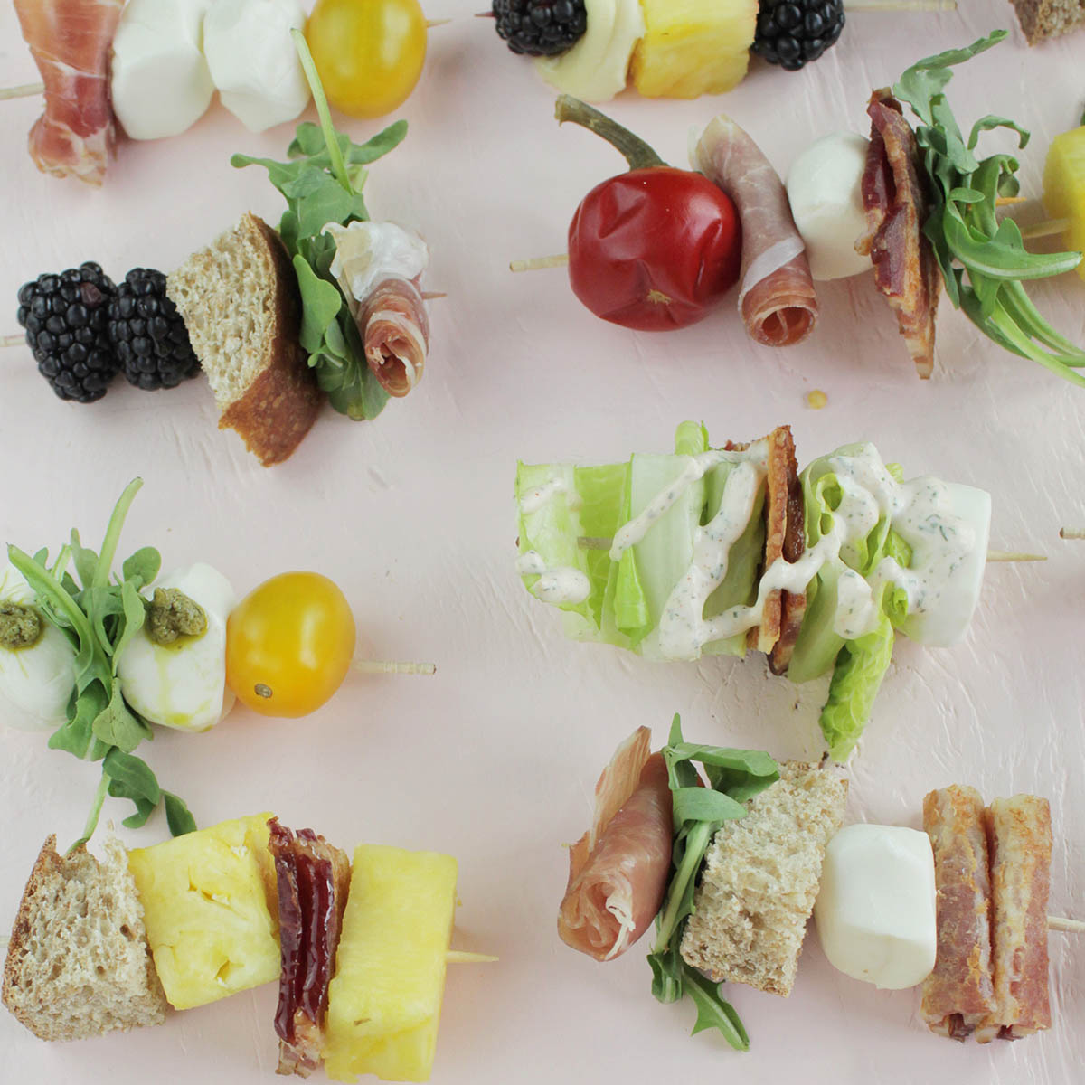 toothpick appetizer skewers on pink background.