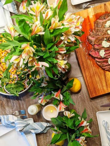 summer tablescape with salad and steak.