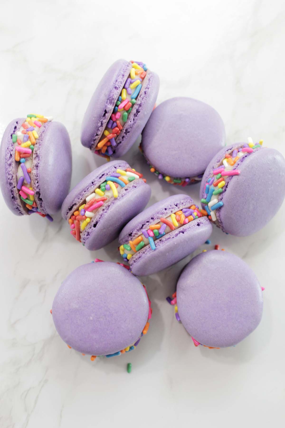purple macarons with rainbow sprinkles.