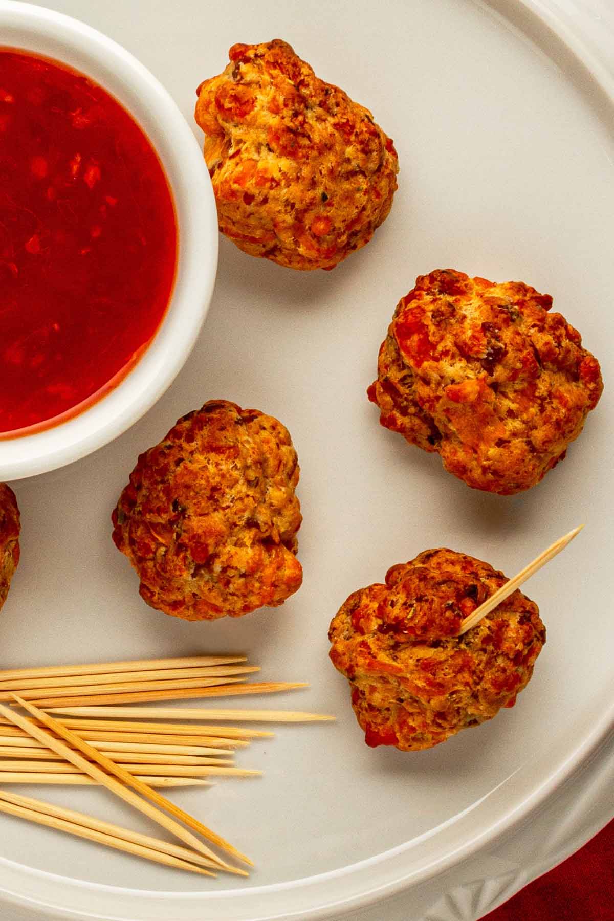 meatballs next to sauce and toothpicks.