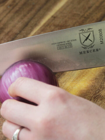 cutting an onion with a chef's knife.